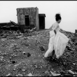 Chien-Chi Chang/ Magnum Photos. Taipei County. 1998. Walking across ruins of a deserted factory in northern Taiwan, this prospective bride seeks an alternative backdrop for her wedding album.